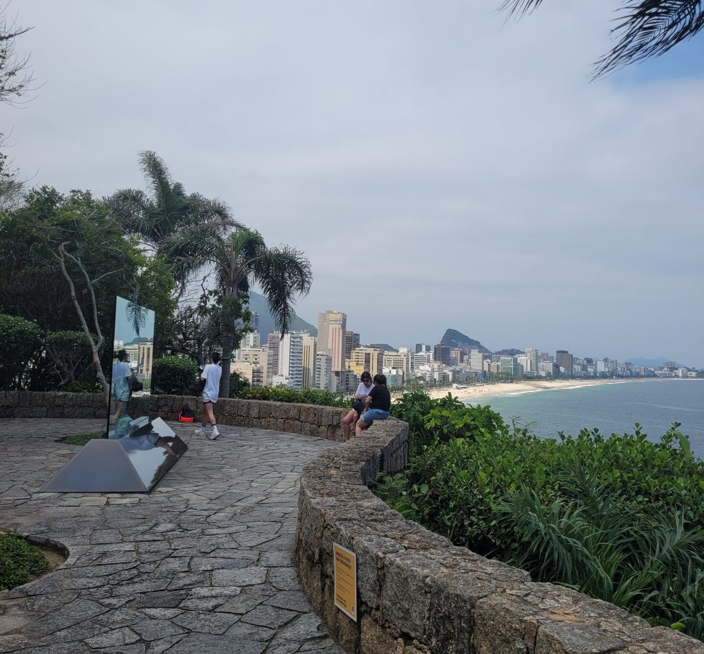 Rio de Janeiro Instagram tour at Mirante do Leblon viewpoint capturing turquoise ocean waves, golden sand beach, and Two Brothers mountain peaks.