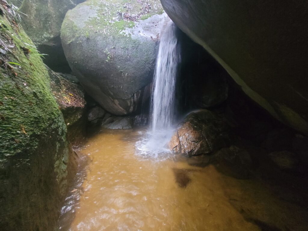 Cascading waterfall in Tijuca National Park rainforest during private full day nature tour from Rio