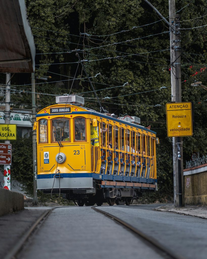 Historic yellow tram on cobblestone streets in Santa Teresa Rio de Janeiro neighborhood