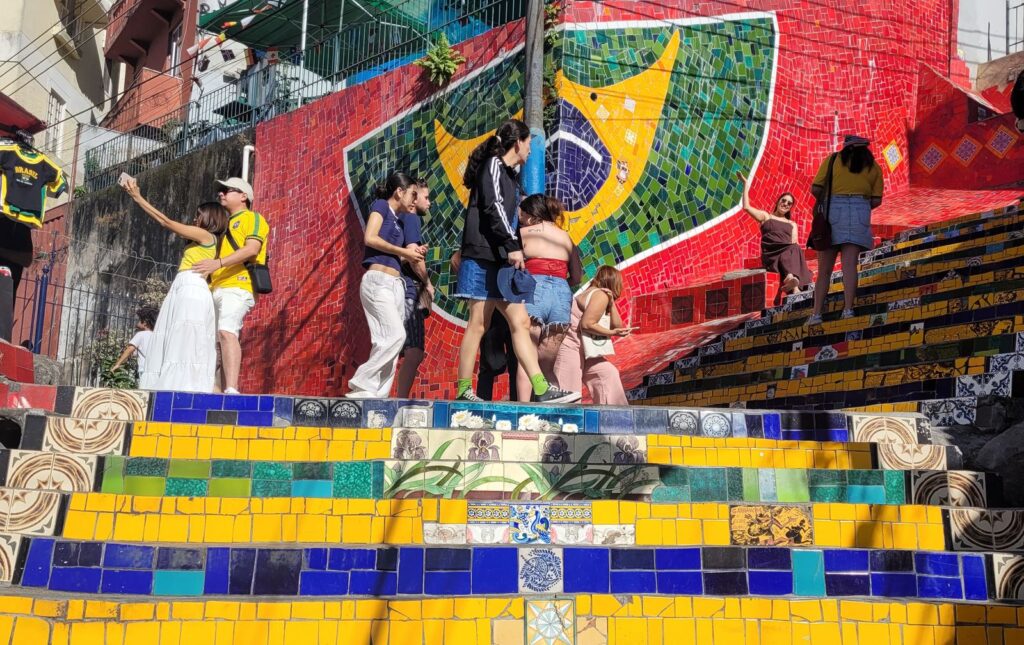 Tourists exploring the colorful mosaic steps of Escadaria Selarón in Lapa, Rio de Janeiro