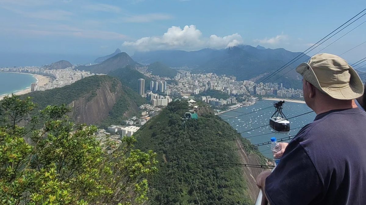 Private multi-day tour in Rio: traveler enjoying the view of Copacabana and the Sugarloaf cable car