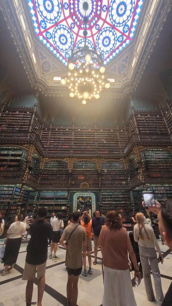 Three storeys of Portuguese volumes under the skylight — now limited to 30 visitors at a time.
