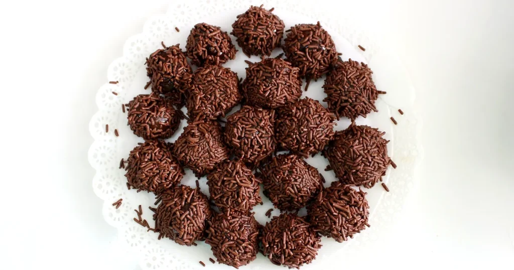 Brigadeiros, the most famous Brazilian dessert, covered in chocolate sprinkles on a white plate in Rio de Janeiro