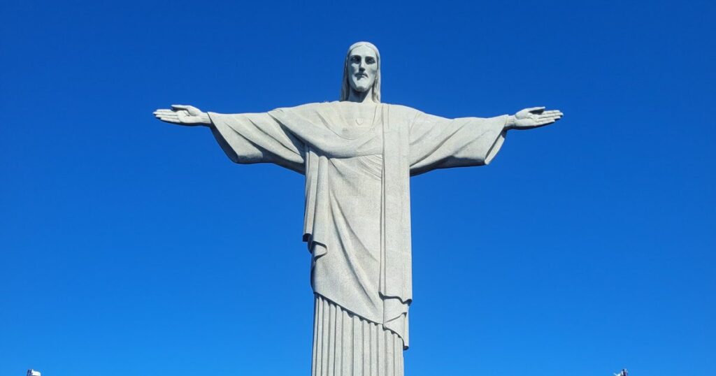 Christ the Redeemer statue with open arms against a clear blue sky – can you climb inside Christ the Redeemer?