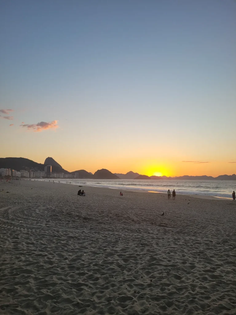 Sunrise over Copacabana beach in Rio de Janeiro with Sugar Loaf Mountain on the horizon
