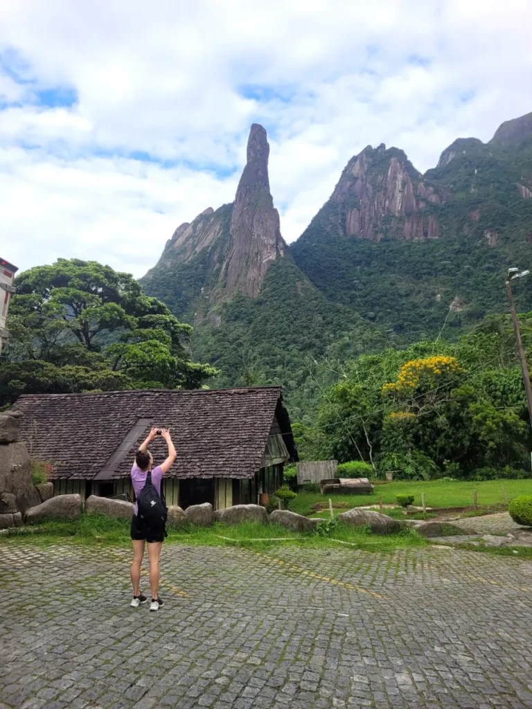 Traveler photographing Dedo de Deus peak in Serra dos Órgãos National Park