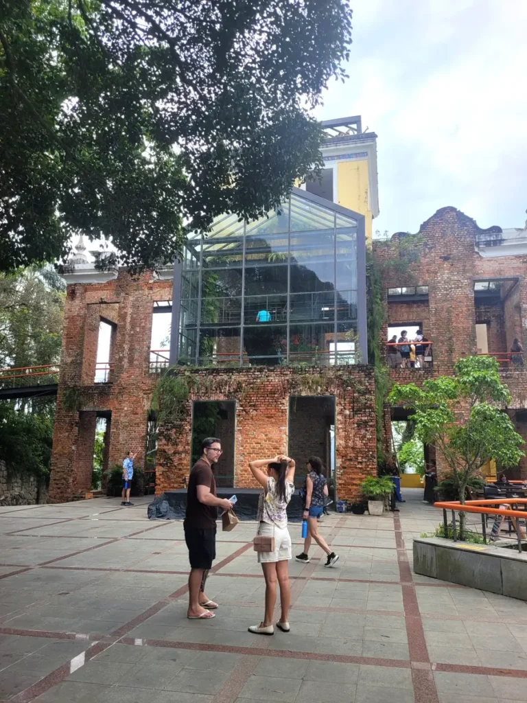 Travelers exploring Parque das Ruínas, a brick mansion ruin turned cultural center in Santa Teresa, Rio