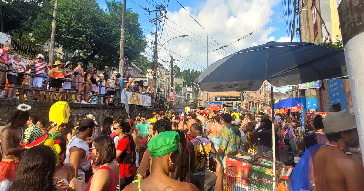 Costumed crowd at a street bloco on the tram tracks of Santa Teresa during Rio de Janeiro Carnival