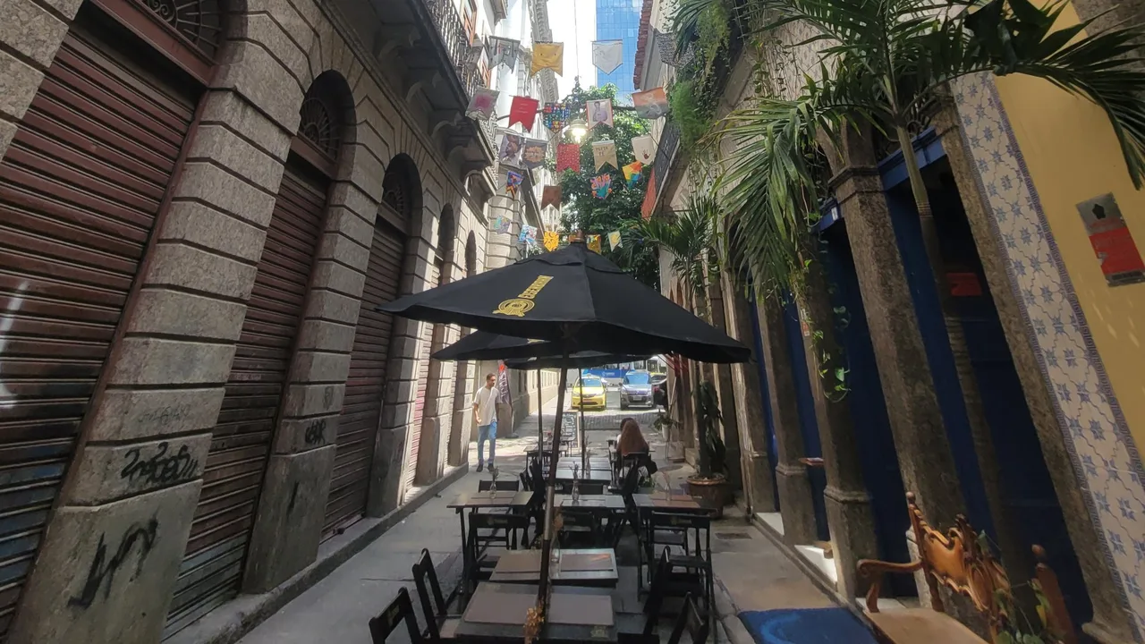 Rio Cultural Secrets pricing for private tours in Rio de Janeiro: colonial alley with colorful flags and outdoor café tables in downtown Rio