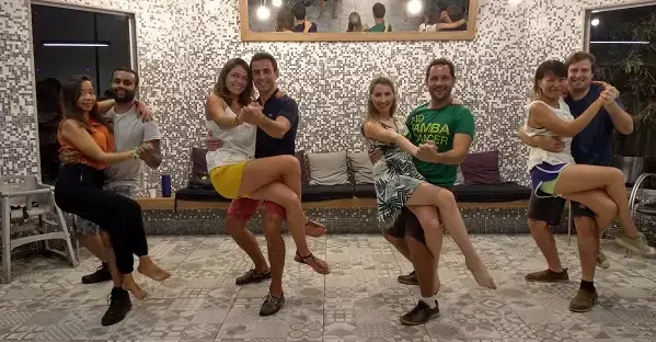 Travelers posing with their instructors during a samba dance class in Rio de Janeiro