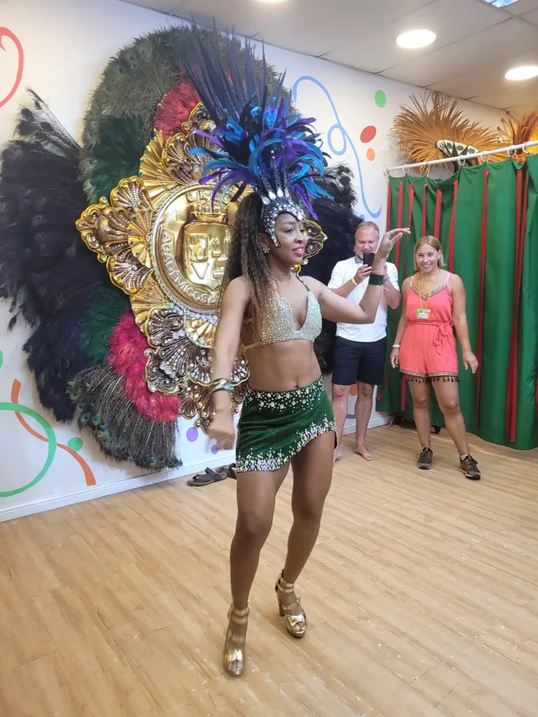 Samba dancer in a feathered headdress and sequined Carnival costume performing for visitors in Rio de Janeiro