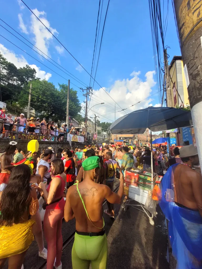 Crowd in colorful costumes at a morning street bloco on the tram tracks of Santa Teresa during Rio Carnival