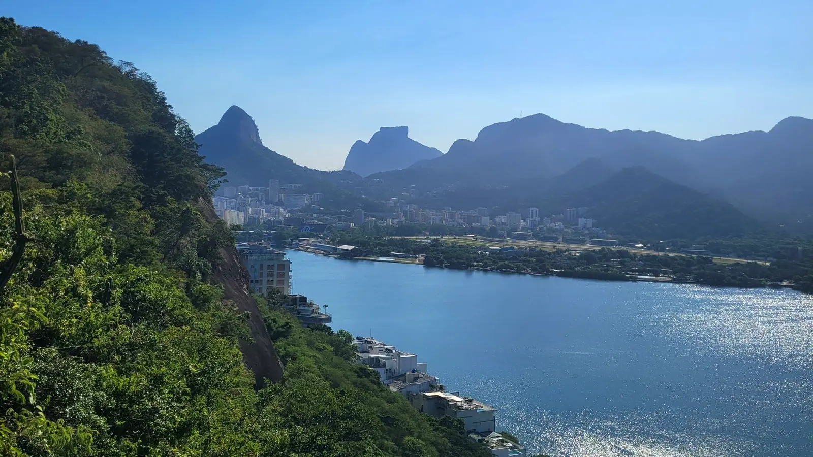 Slow travel in Rio de Janeiro: Rodrigo de Freitas Lagoon and Pedra da Gávea seen from a forest viewpoint